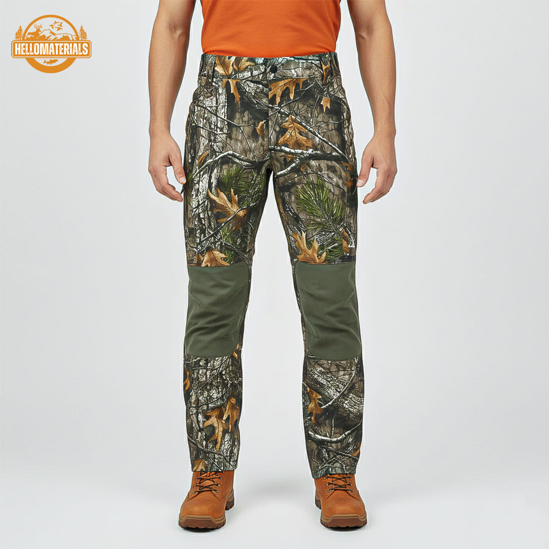 Close-up of durable hunting pants featuring a realistic brown and green camouflage pattern paired with solid olive-green sections, designed for high mobility and concealment in the woods.