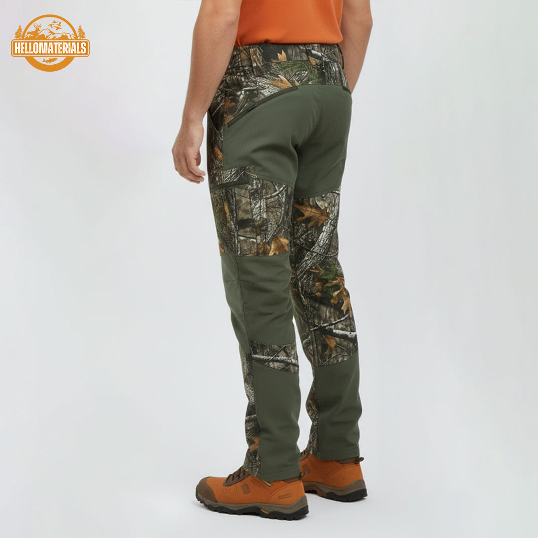 Full side view of a hunter wearing stretch-fit camo pants, blending a detailed woodland pattern with functional dark green fabric for comfort and stealth during outdoor pursuits.